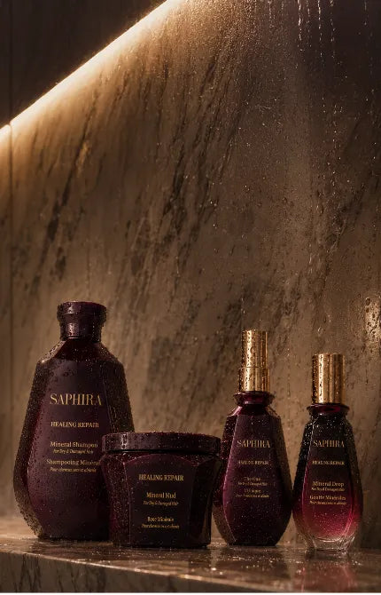 Saphira Healing Repair hair care products on a wet shower ledge